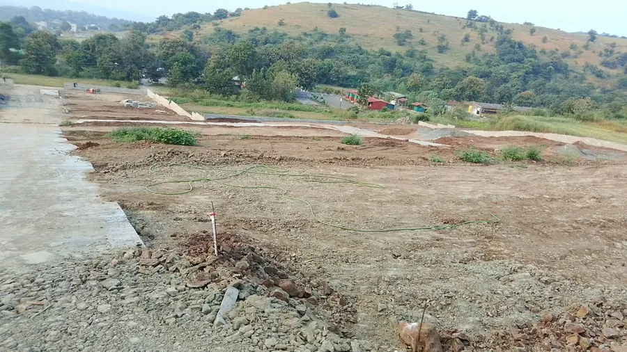 Plots levelled and marked, with the hills behind